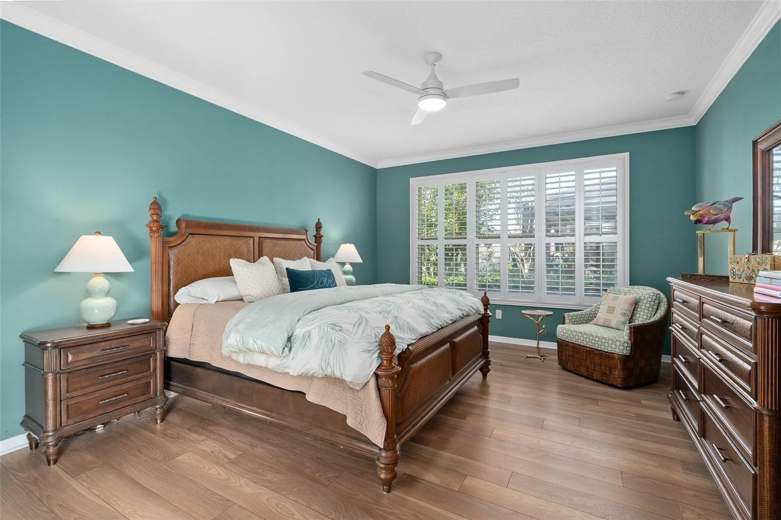 Primary Bedroom suite with Luxury Vinyl Plank Flooring Crown Molding and Plantation Shutters