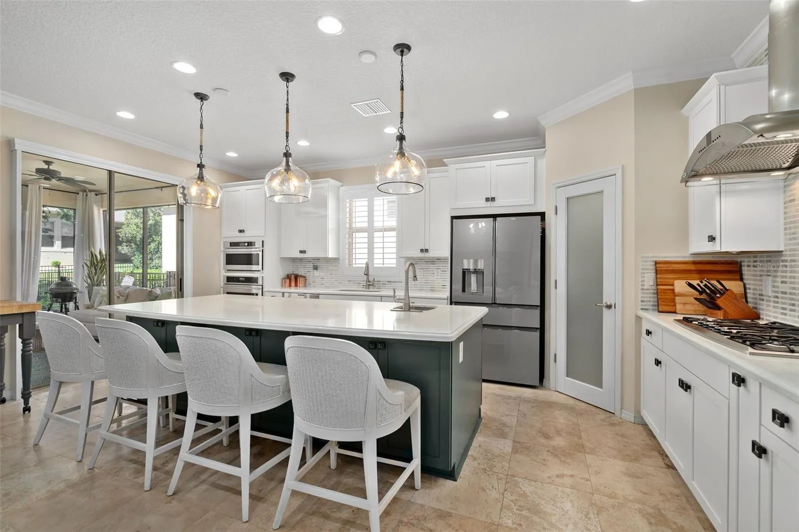 The Gourmet kitchen option includes built-in Monogram Appliances (Cooktop, Built-in Convection Oven, Microwave and Wine Fridge) a Cafe' Glass Front Refrigerator (newer). Island prep sink, Breakfast Bar and Front Facing Cabinetry for additional storage.