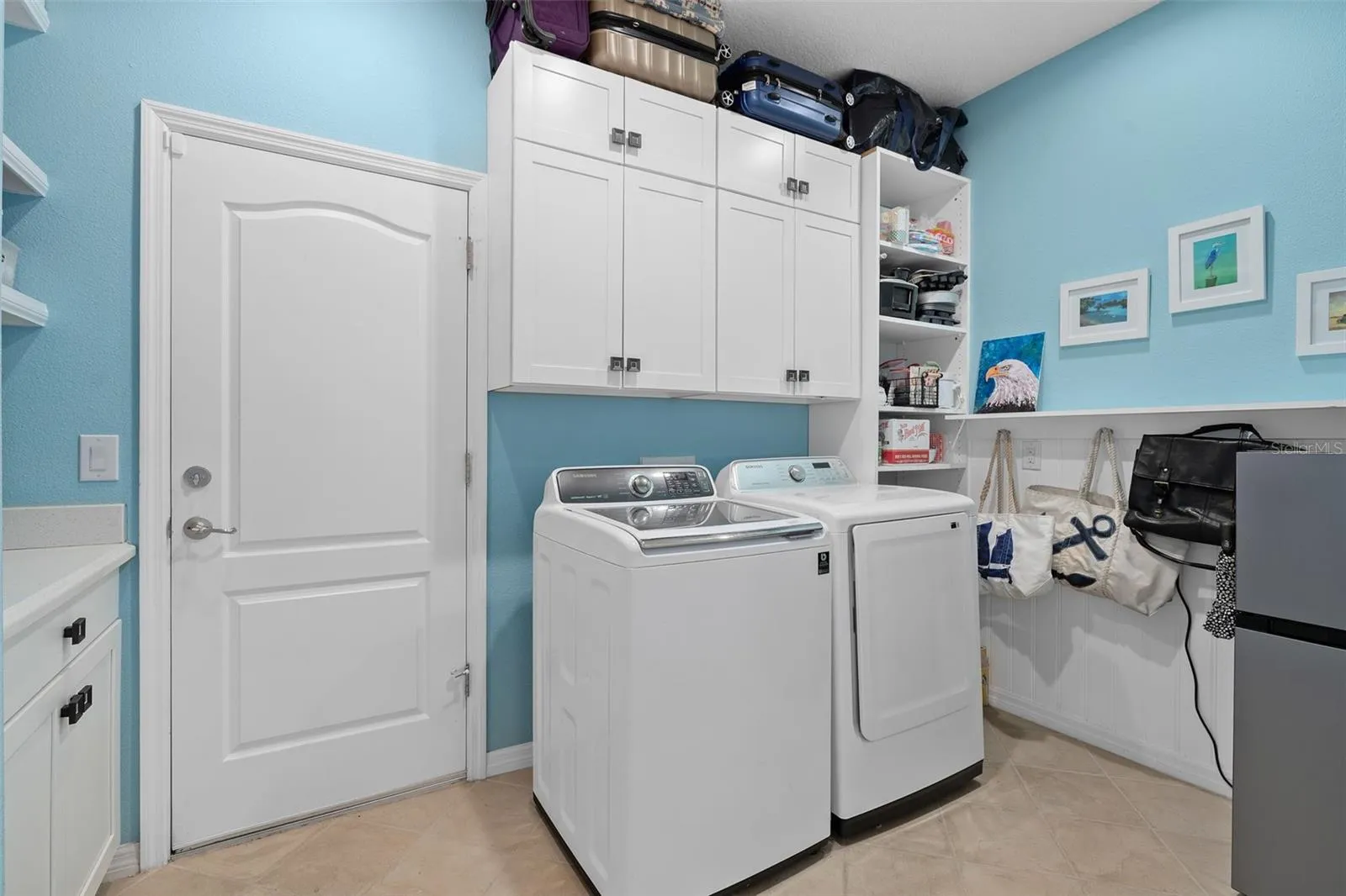 Laundry Room with a Drop Zone, Cabinetry and Custom Wall Treatment