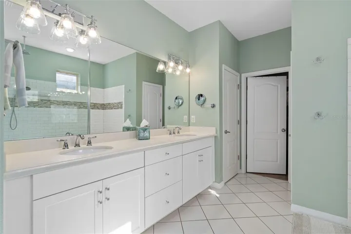 The Primary En-Suite Comfort Height Vanity offers additional center drawers for storage