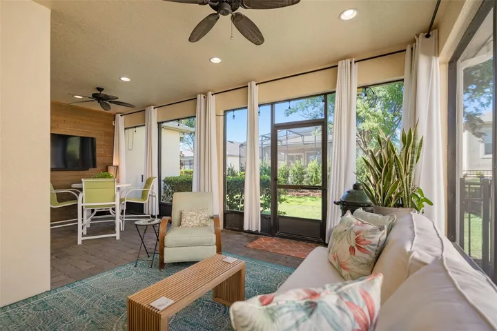 Enjoy the Screened Lanai with a Wood Accent Wall with TV connections, 2 Ceiling Fans and Pavers