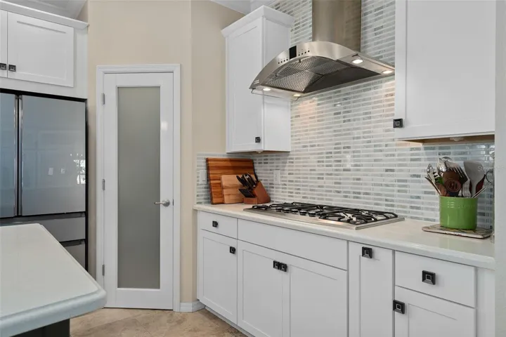 Corner Pantry with a Custom Frosted Glass Door. The Pantry has been outfitted with Custom Organization including a Lazy Susan.