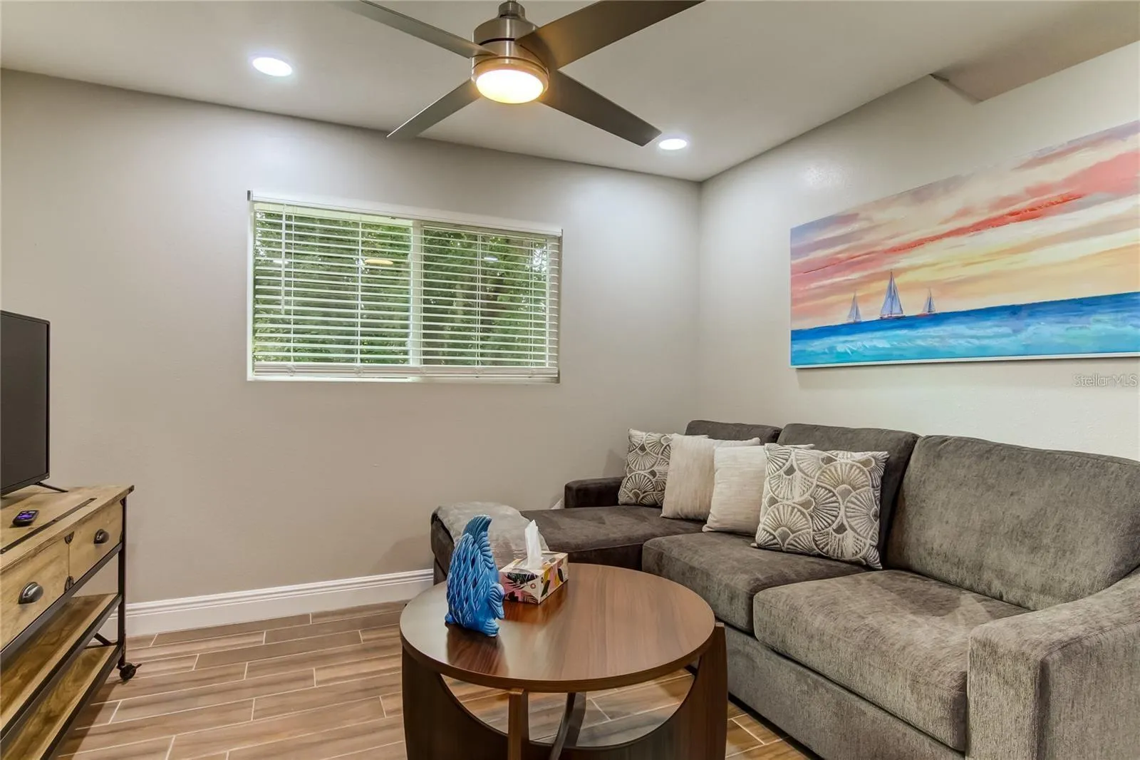 Living Room furnished with couch, tables and tv