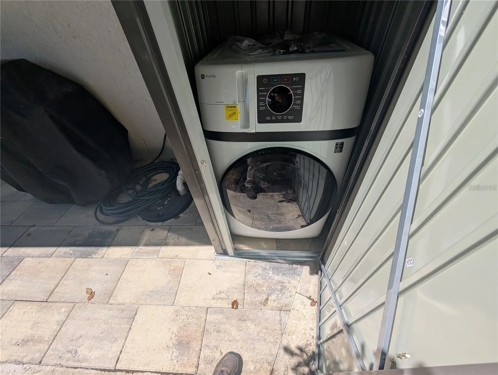 Stackable washer and dryer in outside shed