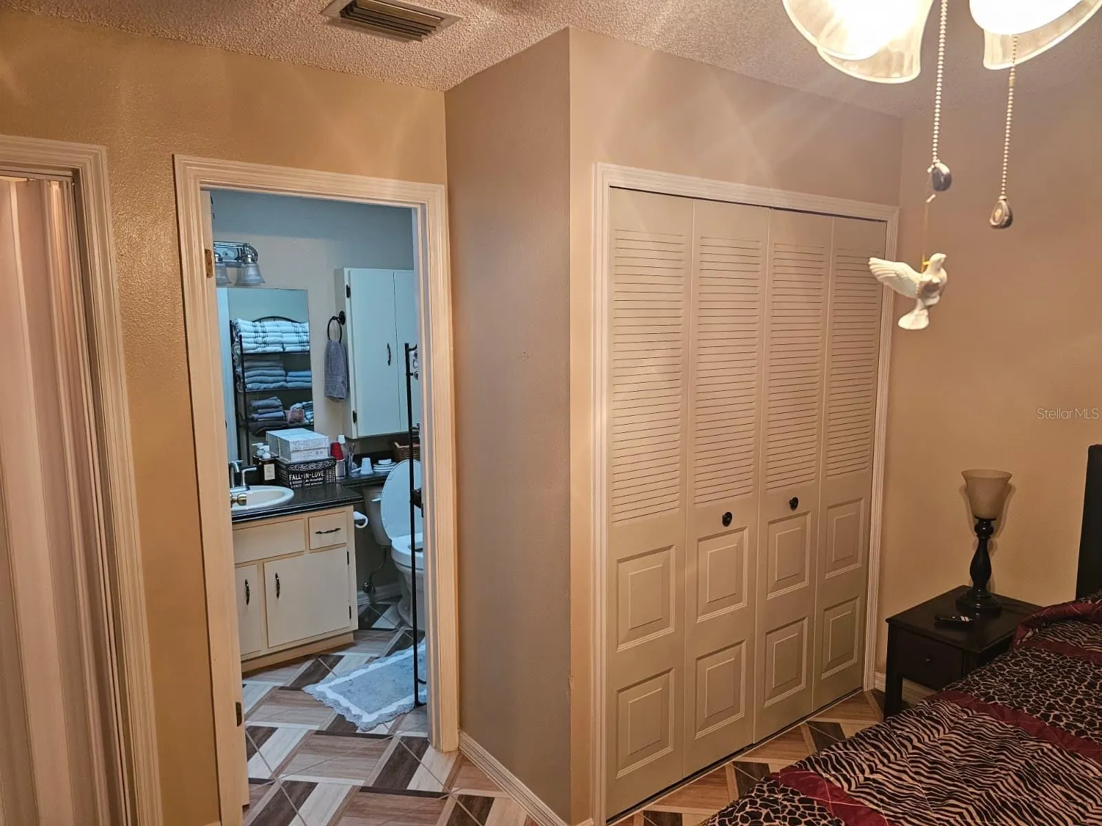 Primary bedroom with closet and door to bathroom