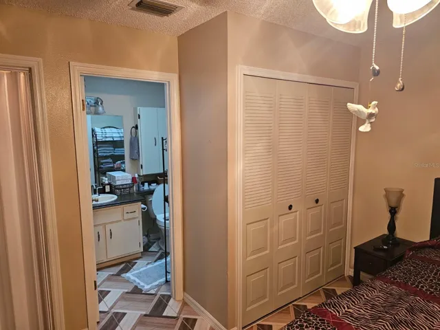 Primary bedroom with closet and door to bathroom