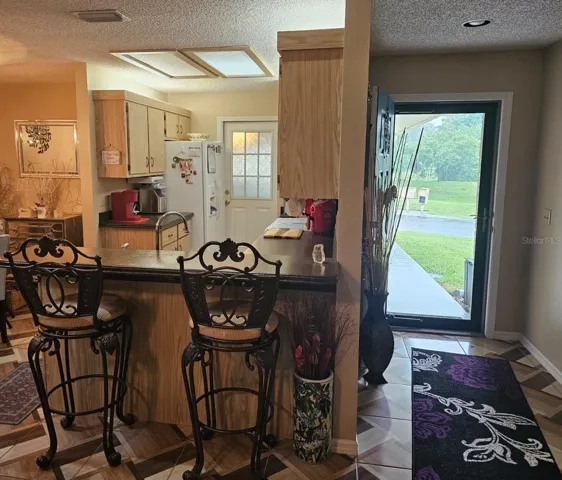 Foyer and bar seating area looking into the kitchen