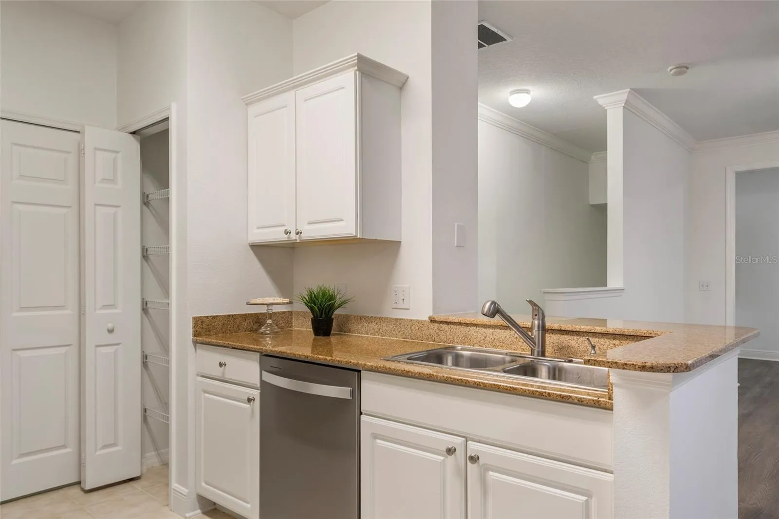 From the dining room you can see a dedicated pantry, additional counter space for prep and a two seater bar top for a quick breakfast or snack.