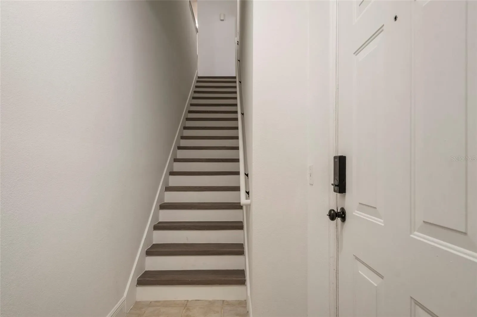 Ascend the stairs and notice the handrail, risers and all interior walls, ceiling and trim are ALL freshly painted.