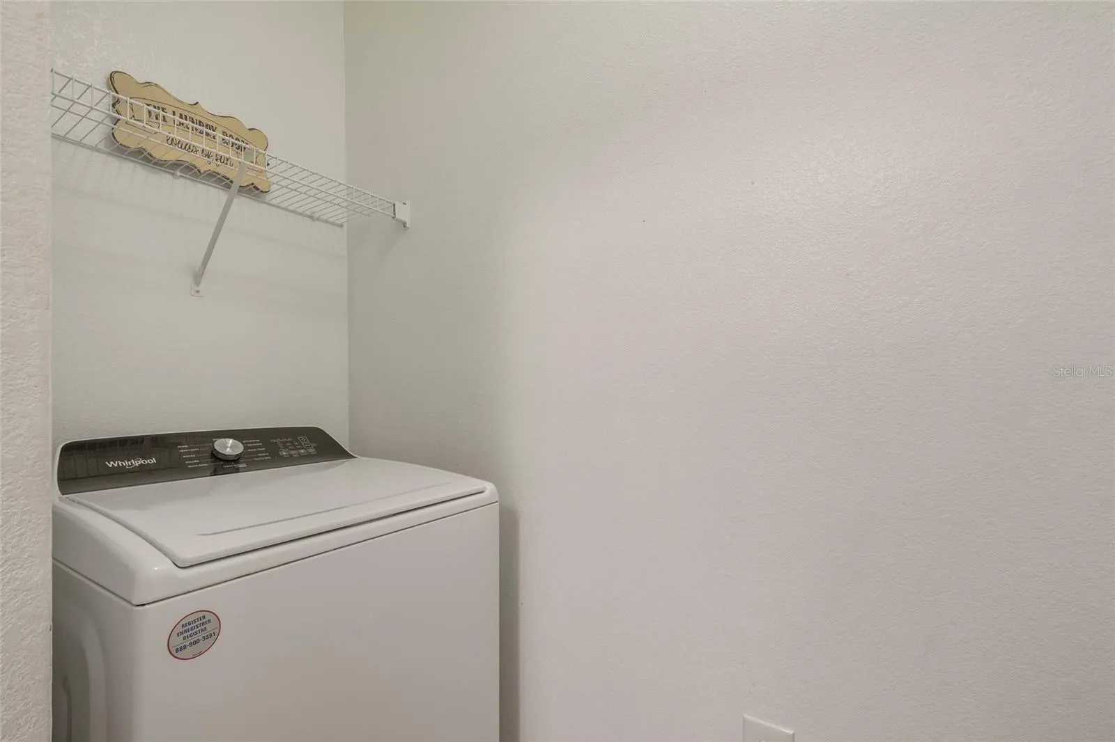 The washer sits opposite the dryer and both are negotiable with the sale of the unit also featuring storage shelving above. All walls freshly painted as if it were brand new.