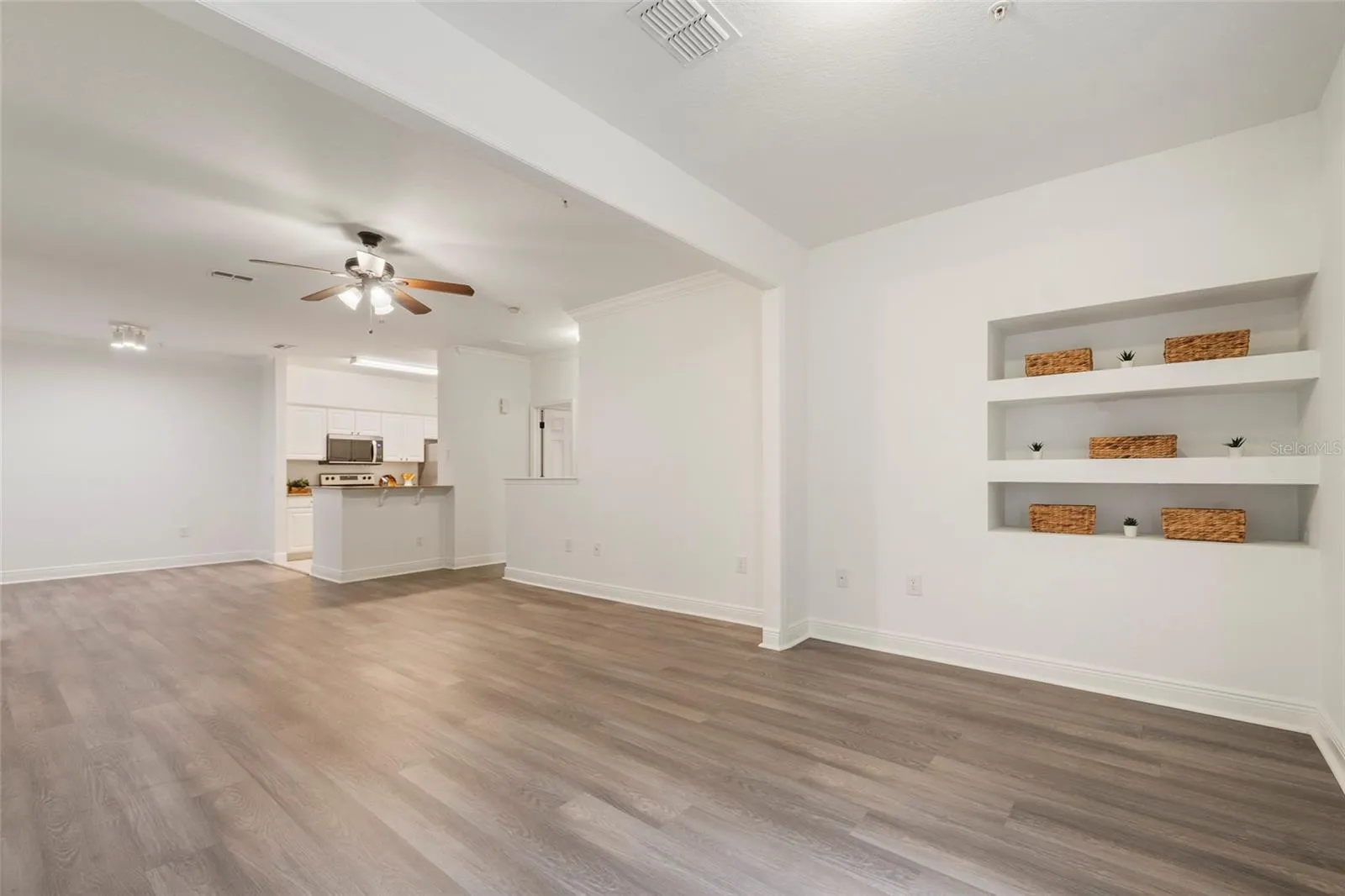 A view from the alcove back into the open concept floor plan. Dedicated space for your dining room table and chairs followed by ample space for family room seating and finished with the alcove area which can extend the family room or become a dedicated office area, work out space or flex room.