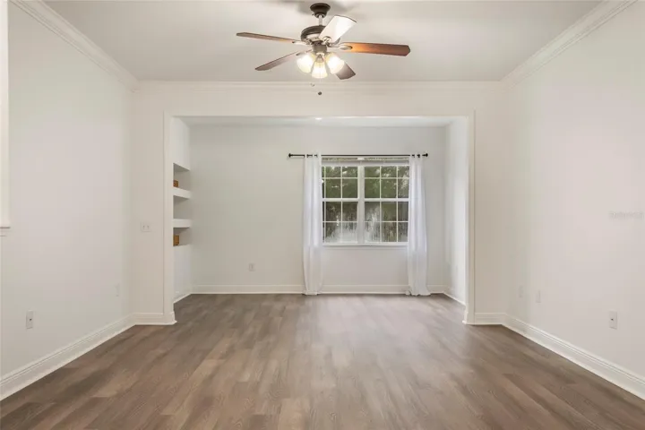 When standing in the dining area a full view of the generously sized family room/alcove room complete with a double window for a lovely view of the mature trees that surround the unit.