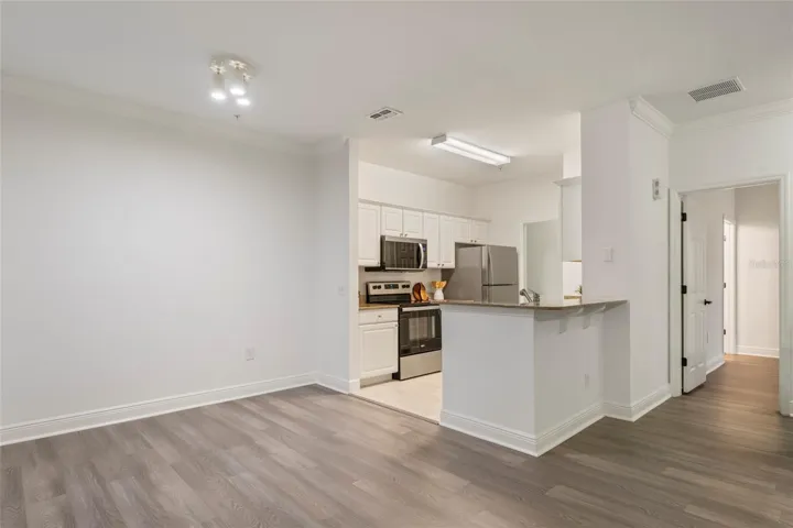 From the dining area looking into the kitchen and laundry rooms. Note the overhang counter top with your own stools it makes a great place for a quick breakfast or after school snack.