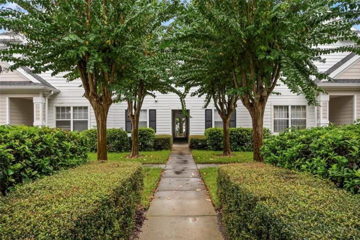 Well manicured mature landscaping greets you as you approach building 14, unit 208