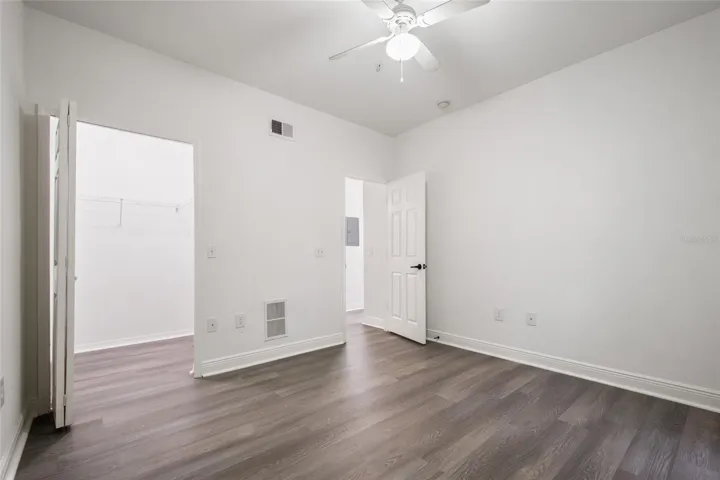 Bedroom 3 features all luxury plank vinyl all the way through the walk in closet, ceiling fan, freshly painted walls, ceilings, trim and door with a new lever handle it is ready for its new owner.