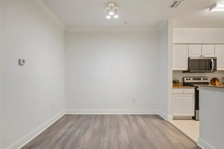 A photo of the defined dining area, ample room for a table and chairs to seat 6-10 depending on your family size.