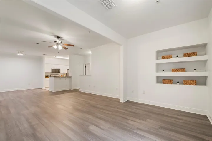 A view from the alcove back into the open concept floor plan. Dedicated space for your dining room table and chairs followed by ample space for family room seating and finished with the alcove area which can extend the family room or become a dedicated office area, work out space or flex room.