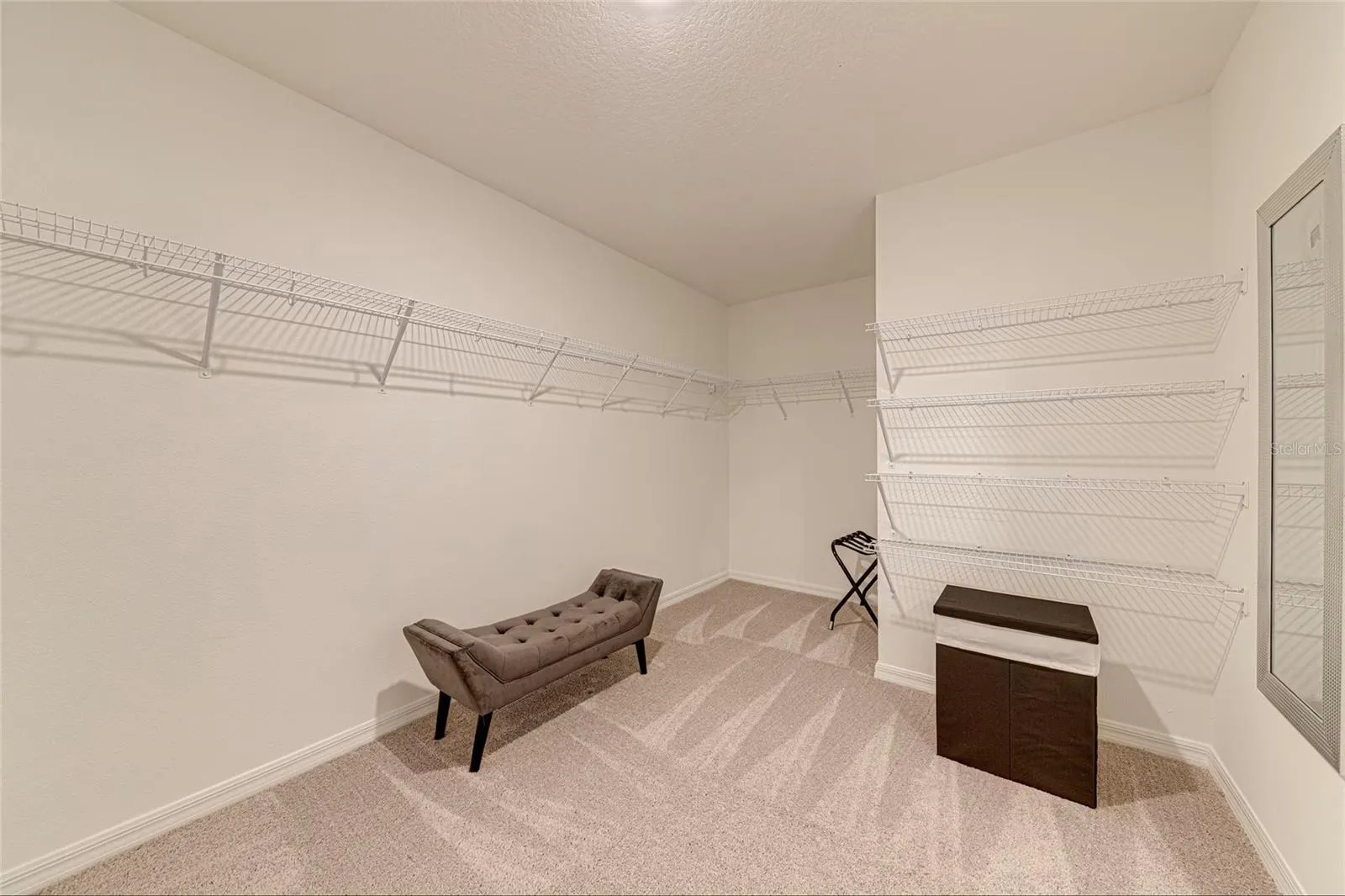 12. Walk-In Closet    Generous walk-in closet providing excellent storage space for the primary suite.
