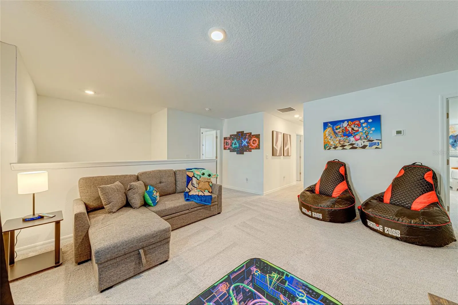 13. Loft    Spacious upstairs loft offering an additional TV lounge and entertainment area.
