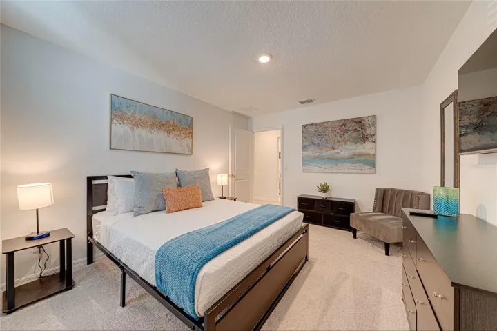 19. Bedroom 3    Inviting furnished bedroom with TV and a comfortable, functional layout.