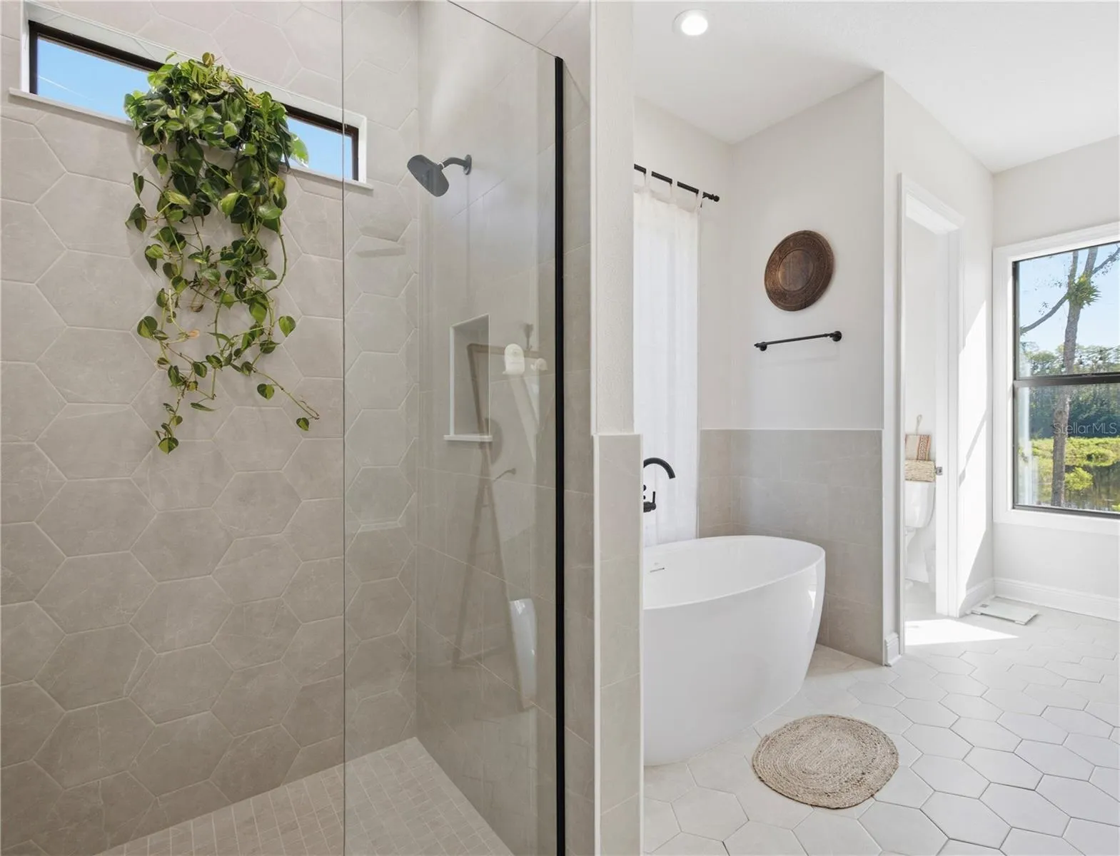Primary bathroom, combination of modern freestanding tub and walk-in shower with tons of natural light
