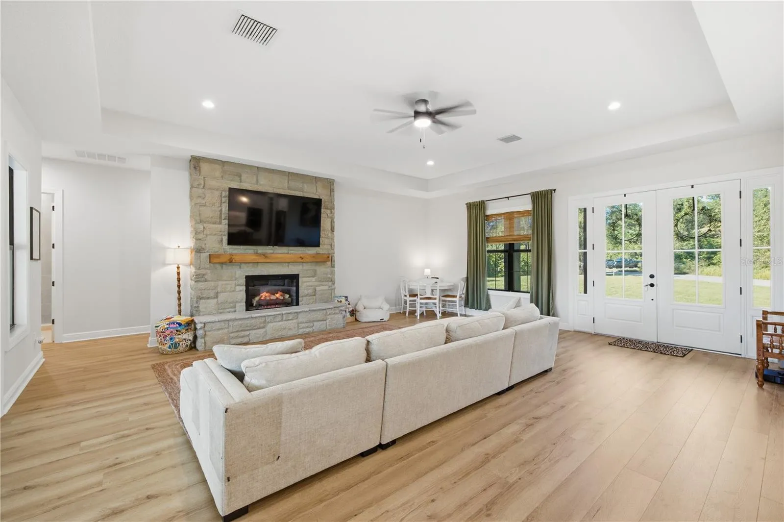 Tons of natural lights and stone detailed electric fireplace.