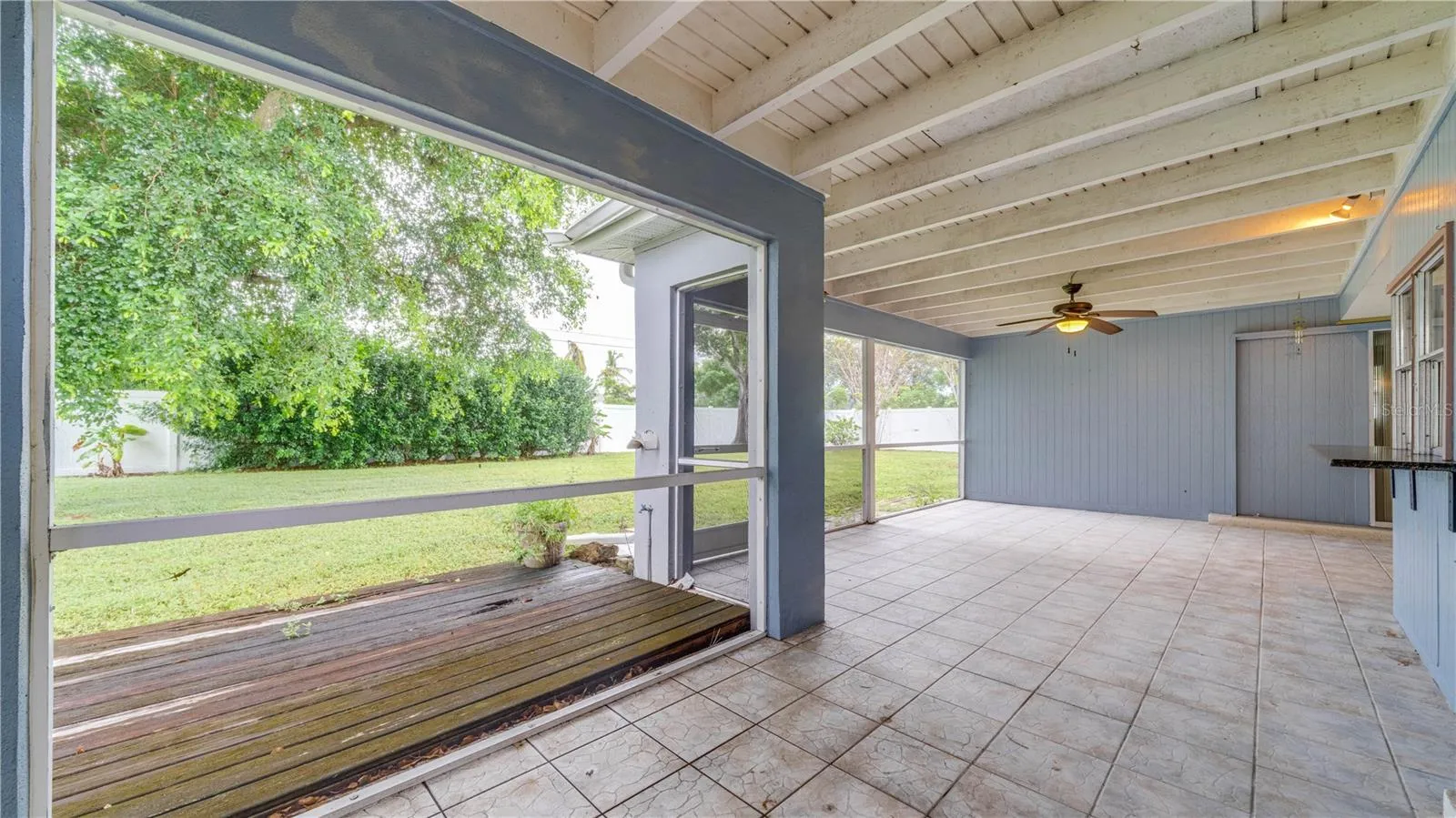The oversized, tiled lanai showcases an exposed beam ceiling and so much room for your outdoor oasis.