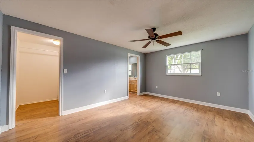 Freshly painted Primary Suite with a walk-in closet.
