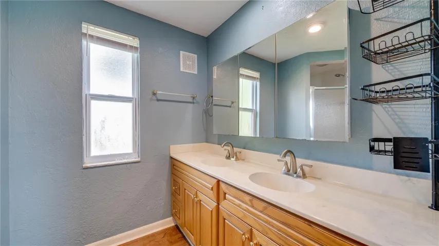 Primary Bath offers dual sinks, a walk-in shower, and brushed nickel fixtures.