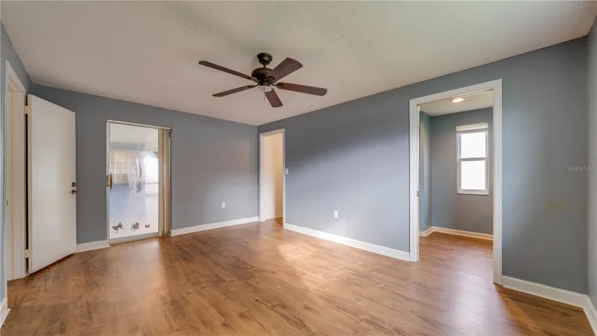 The Primary Suite provides access to the tiled lanai.