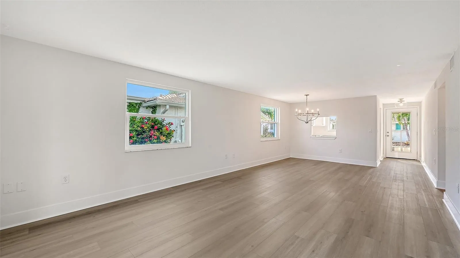The entry door, Kitchen on the left, Dining Room/ Living Room combination.