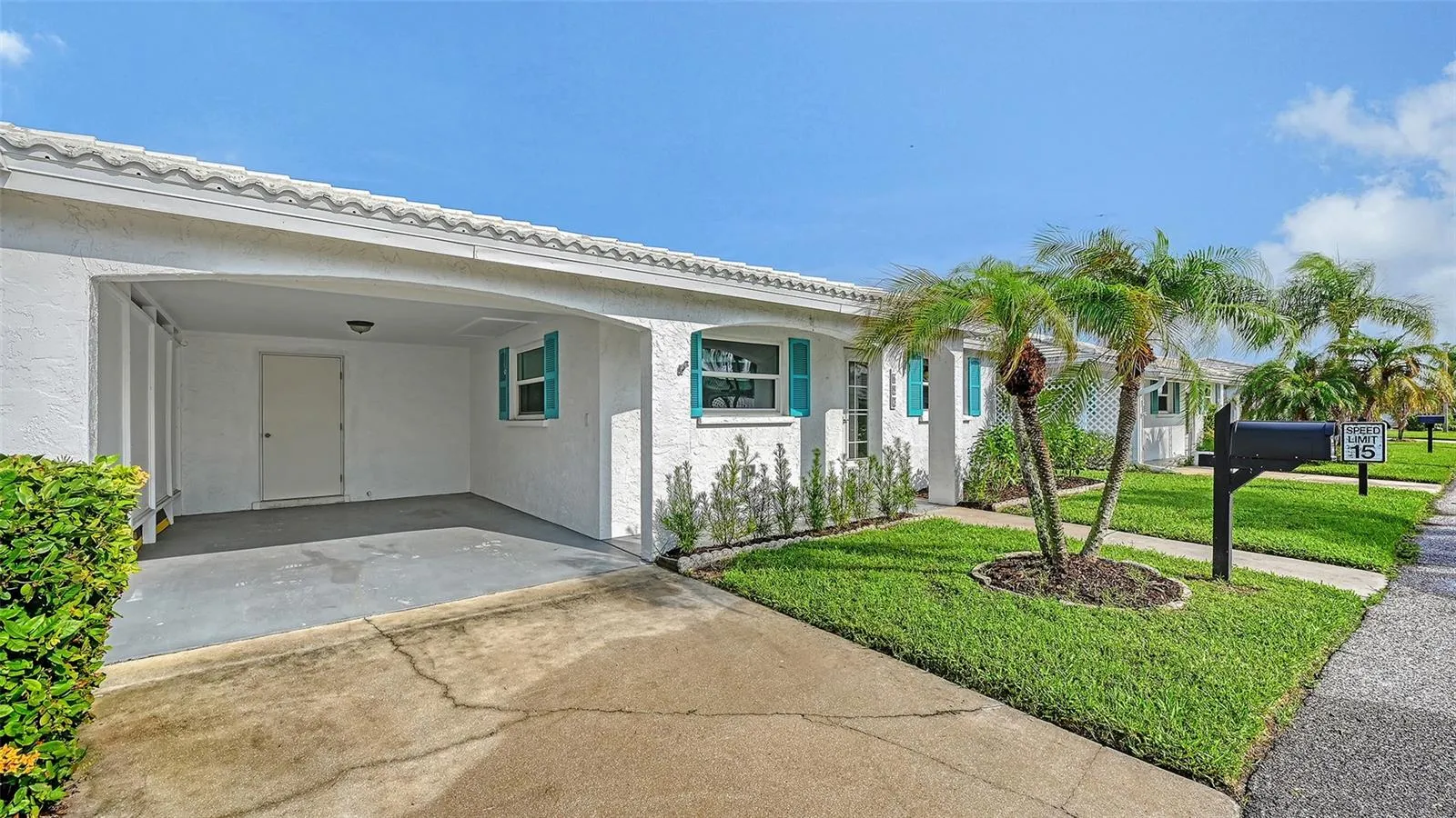 The villa with the carport and storage room.
