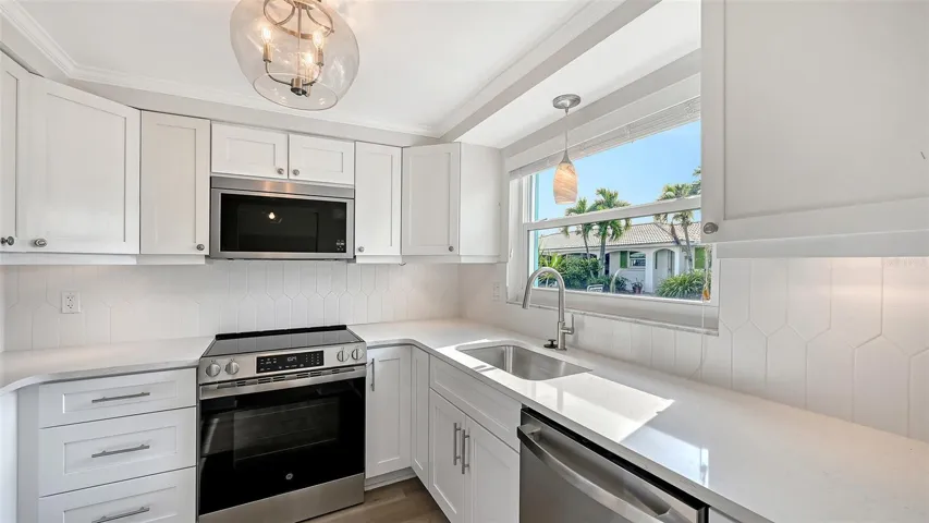 New Kitchen with stone countertops and stainless steel appliances.