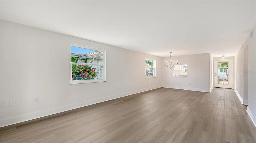 The entry door, Kitchen on the left, Dining Room/ Living Room combination.