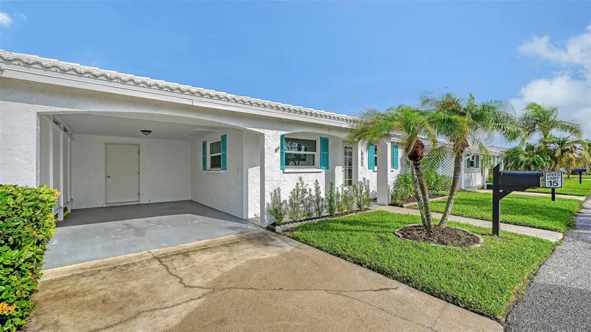 The villa with the carport and storage room.