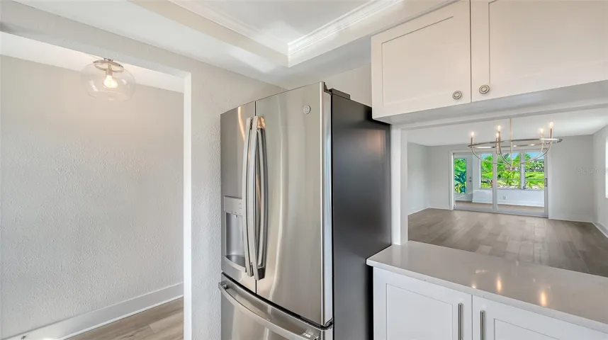 New Kitchen with stone countertops and stainless steel appliances. Pass through to Dining Room.