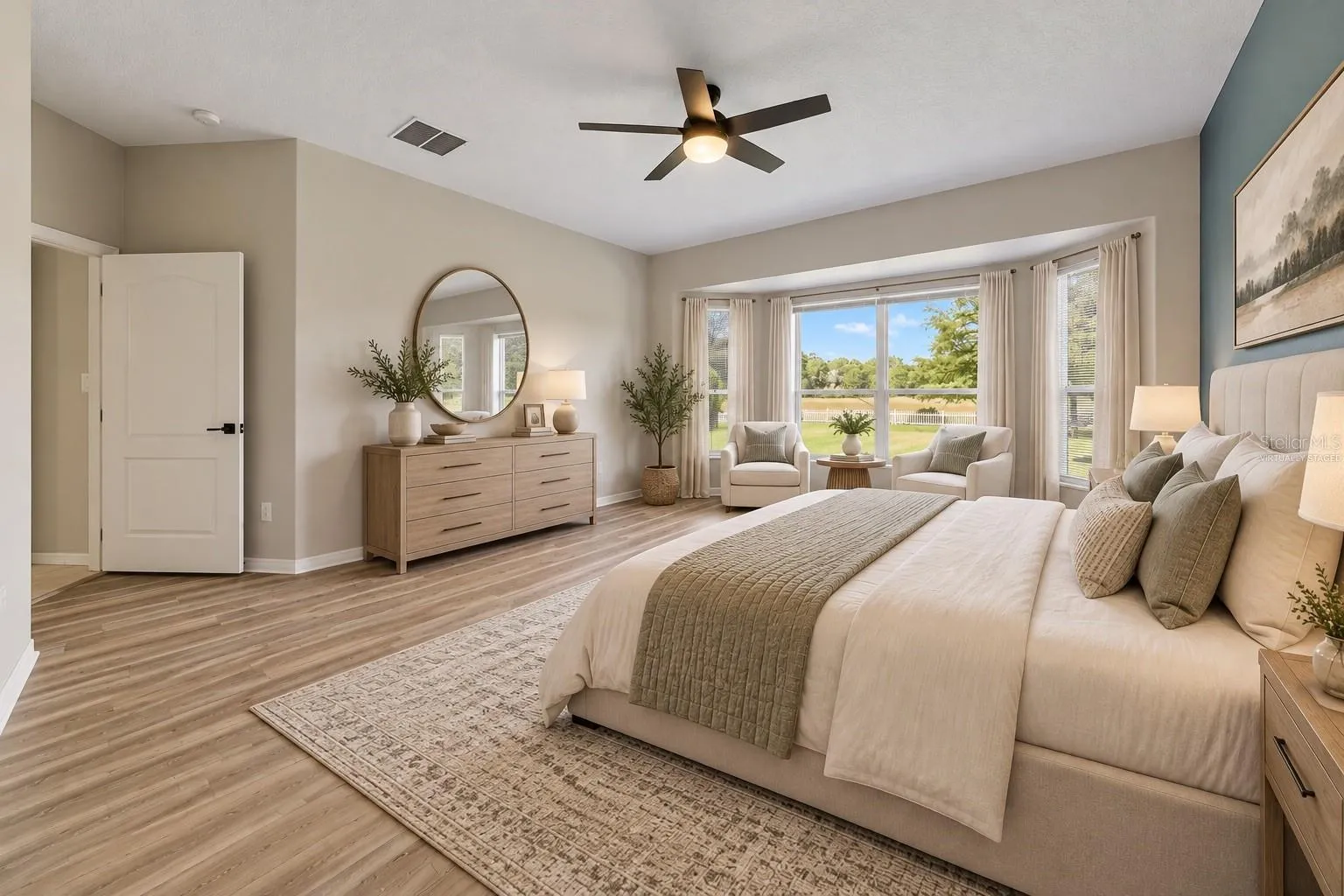 The FIRST-FLOOR PRIMARY SUITE presents a private retreat with LVP FLOORING and a bay window that fills the room with NATURAL LIGHT. Virtually Staged