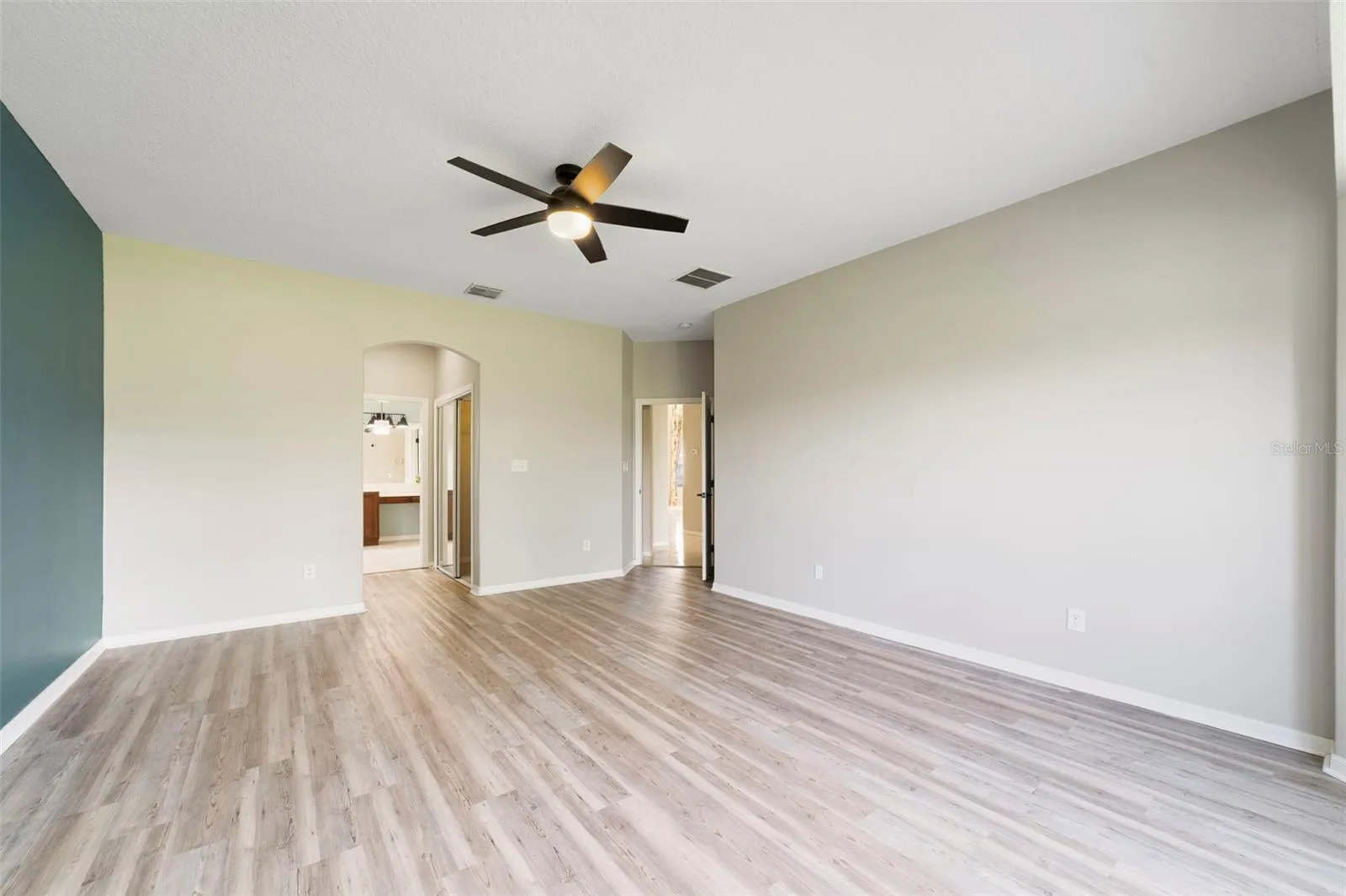 The FIRST-FLOOR PRIMARY SUITE presents a private retreat with LVP FLOORING and a bay window that fills the room with NATURAL LIGHT.