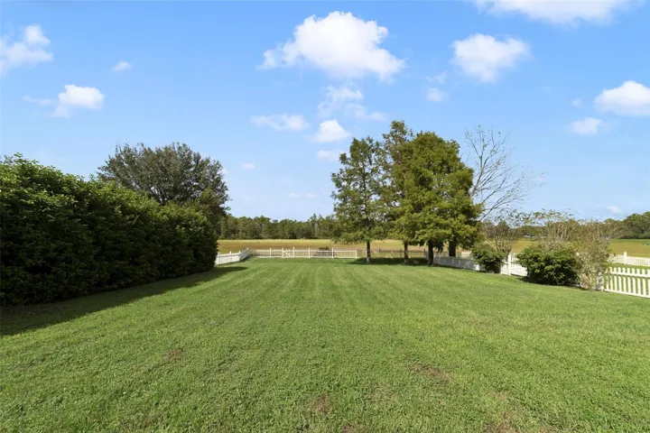 The spacious backyard is enclosed by a VINYL PICKET FENCE and backs to a CONSERVATION AREA providing a peaceful backdrop to enjoy the outdoors.