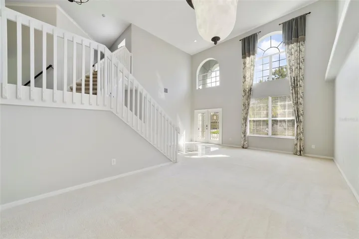 The formal LIVING ROOM/DINING ROOM COMBO share an elegant, open setting enhanced by 2-STORY CEILINGS where a chandelier and decorative ceiling medallion create a lovely atmosphere for hosting holidays and special occasions.
