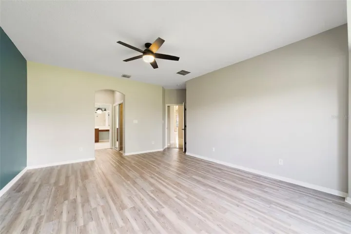 The FIRST-FLOOR PRIMARY SUITE presents a private retreat with LVP FLOORING and a bay window that fills the room with NATURAL LIGHT.
