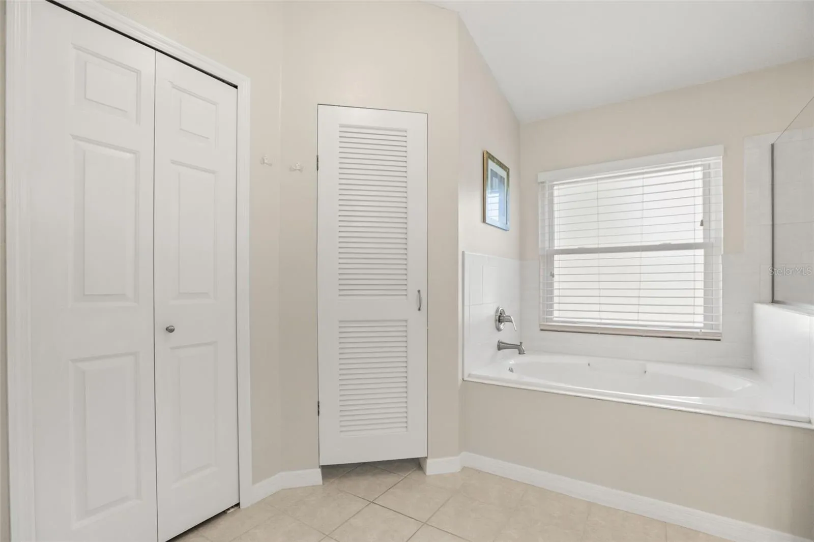 Primary ensuite garden tub with private restroom