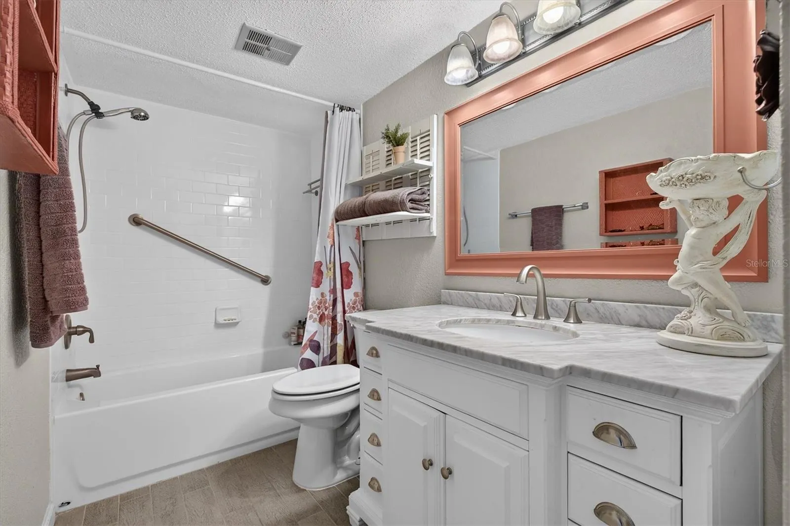 Modern bath with tub, shower, large vanity and linen closet.