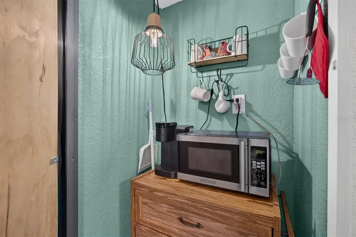 Pantry closet with microwave and storage.