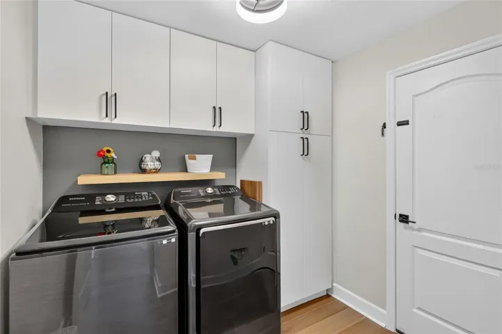 Laundry room with lots of cabinet space the owners added.