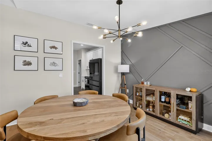 Plenty of room for a larger dining room table. Look at that upgraded light fixture