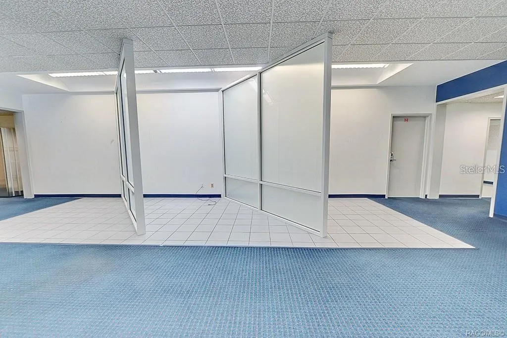 Interior view showing the open area and existing office partitions.