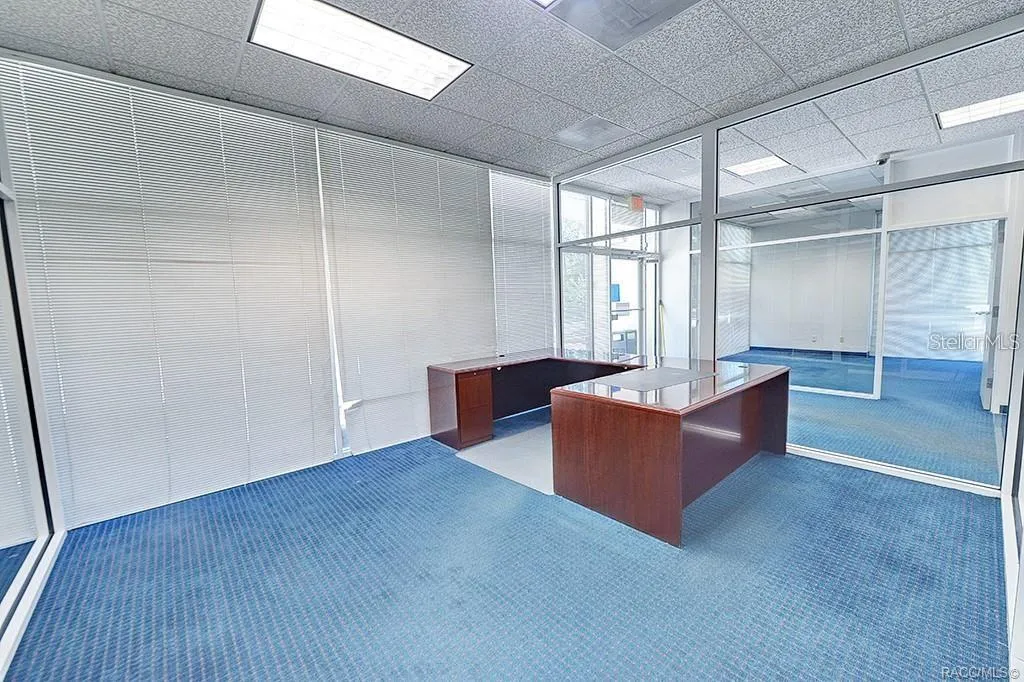Glass-partitioned office with views across the interior.