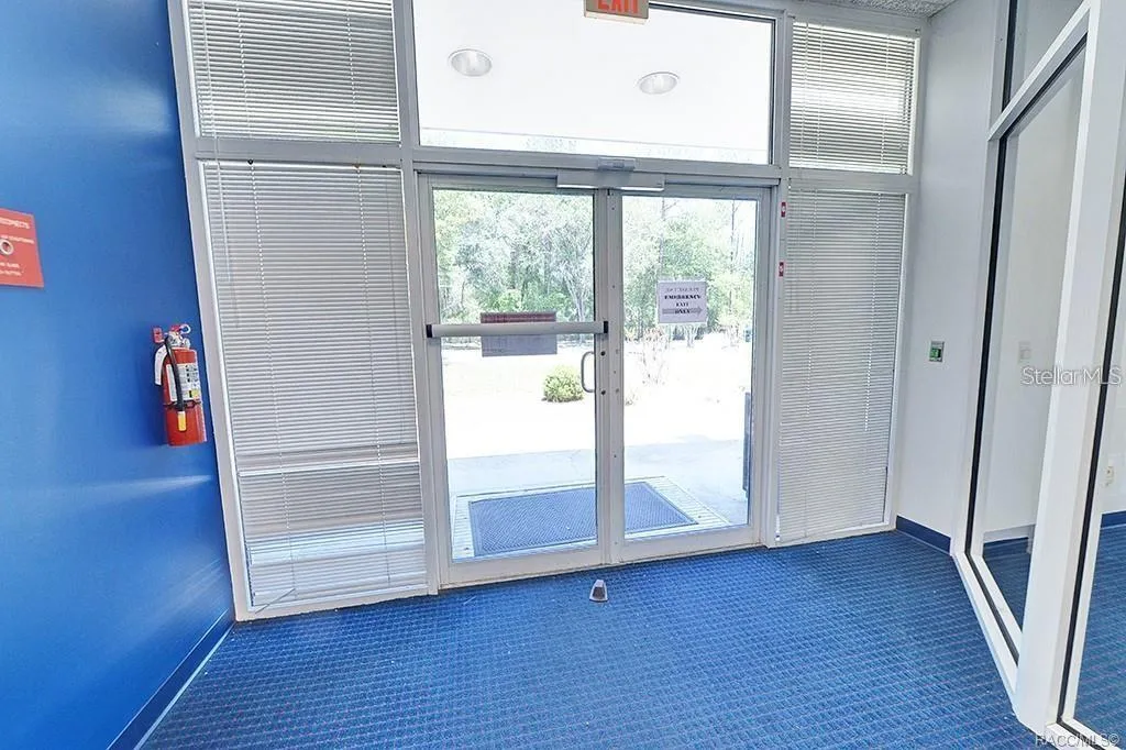 Interior view toward the glazed building entrance.