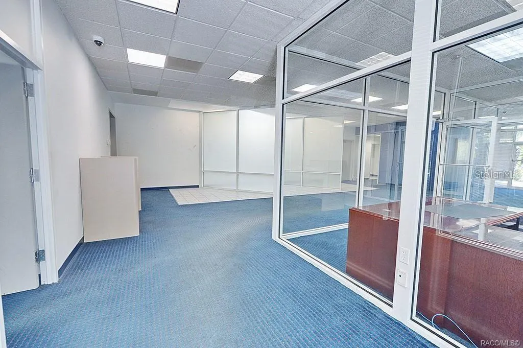 Open customer area with glass-partitioned office space.